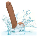 Dual Density Silicone Stud Dildo 5 inches Brown with real feel shaft and suction cup base splashing in water.