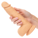 Hand holding Dual Density Silicone Stud 6.25 inches Ivory Dildo with realistic texture and suction cup base.