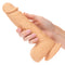 Hand holding Dual Density Silicone Stud 6.25 inches Ivory Dildo with realistic texture and suction cup base.
