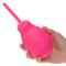 A hand holding a pink Cheeky One Way Flow Douche featuring a slender nozzle for intimate hygiene and comfort.
