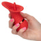 Hand holding compact red French Kiss Seducer Massager by California Exotic Novelties, rechargeable vibrator for powerful, flickering sensations