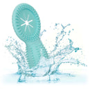 Aqua blue silicone vibrating cock ring splashing in water, showcasing waterproof design.