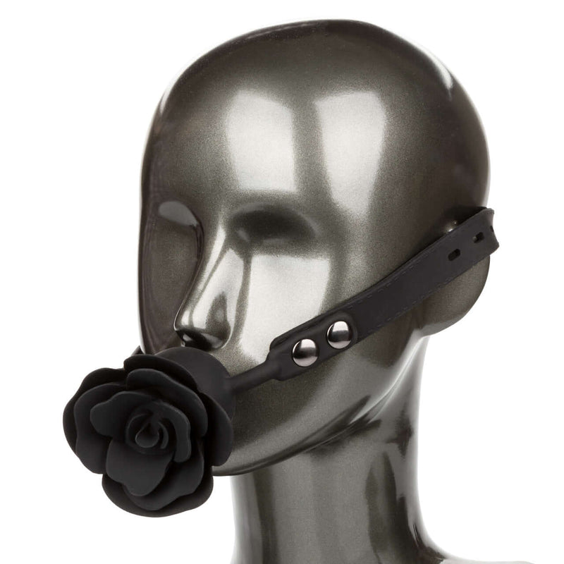 Adjustable ball gag with removable rose accent on mannequin for BDSM play
