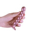 Hand holding Ouch! Beaded Silicone G-Spot Dildo 5 inches in Rose Gold with strong suction cup.