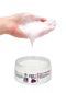 "Hand holding Shots Toys PharmQuests Fist It Anal Relaxer, 300ml, with product jar open below"