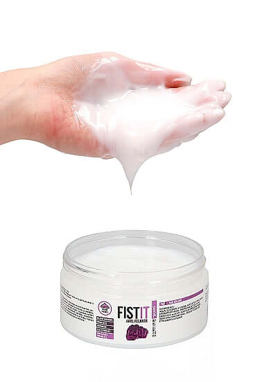 "Hand holding Shots Toys PharmQuests Fist It Anal Relaxer, 300ml, with product jar open below"
