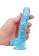 Hand holding clear blue Realrock Cock 6-inch realistic dildo with balls and suction cup, by Shots Toys America
