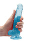 Realrock 7 inches blue realistic dildo with balls and suction cup being held, phthalate and latex free, by Realrock Crystal Clear series.