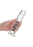 Realrock Clear Realistic Dildo 8 inches held in hand, showcasing crystal clear design for anal and vaginal pleasure from Shots Toys.