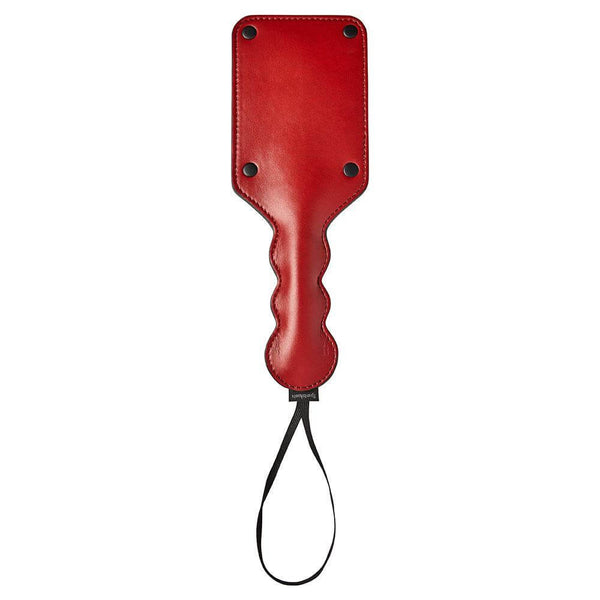 Sturdy red Sportsheets Saffron Square Paddle with a smooth vegan leather finish, perfect for sensual play and punishment.