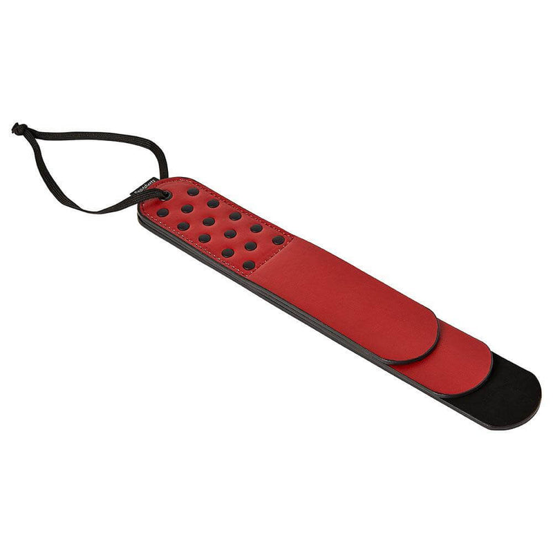 Sportsheets Saffron Layer Paddle featuring three layers of red vegan leather for impact play and enhanced sensations.