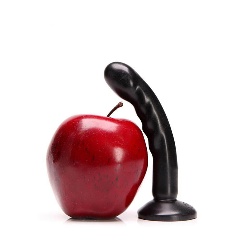 Tantus Silicone Compact Black Dildo beside a red apple for size comparison, highlighting its small, beginner-friendly design.