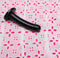 Silk Medium Black Dildo from Tantus Silicone on pink embroidered fabric