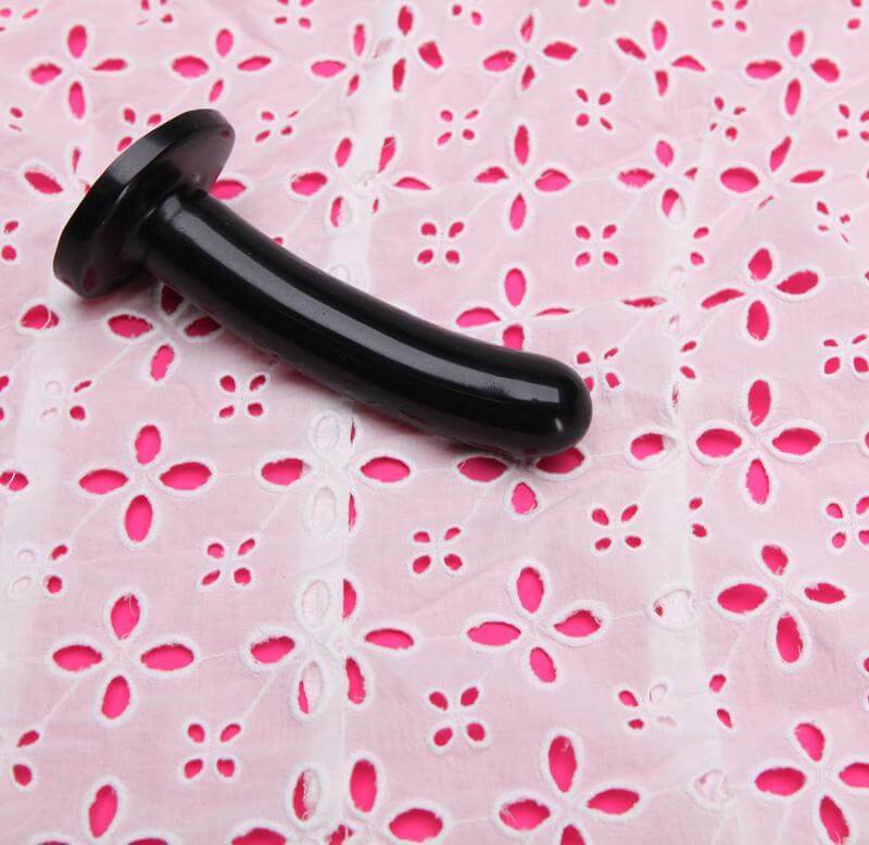 Silk Medium Black Dildo from Tantus Silicone on pink embroidered fabric
