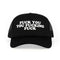 Trucker-style hat with bold text in white, adjustable snapback, black mesh design.