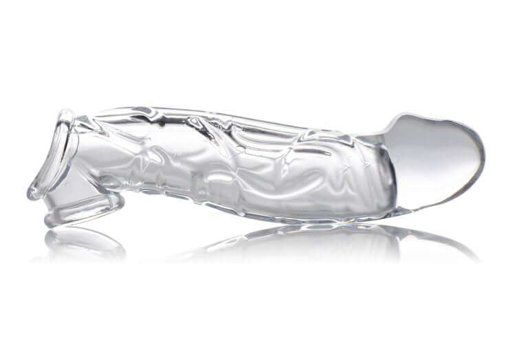 Size Matters 2-Inch Clear Extender Sleeve with Realistic Texture & Extra Length displayed on a reflective surface.