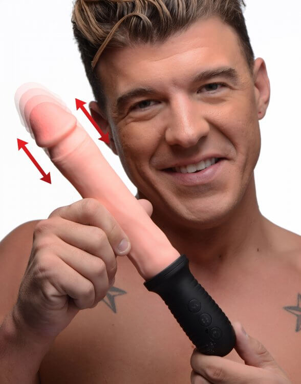 Person holding XR Brands Master Series 8X Auto Pounder Beige Dildo, showcasing its vibrating and automatic thrusting feature.