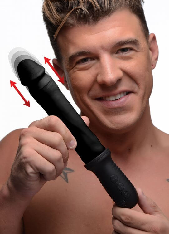 Man holding Master Series 8X Auto Pounder black dildo showcasing automatic thrusting and vibration features.