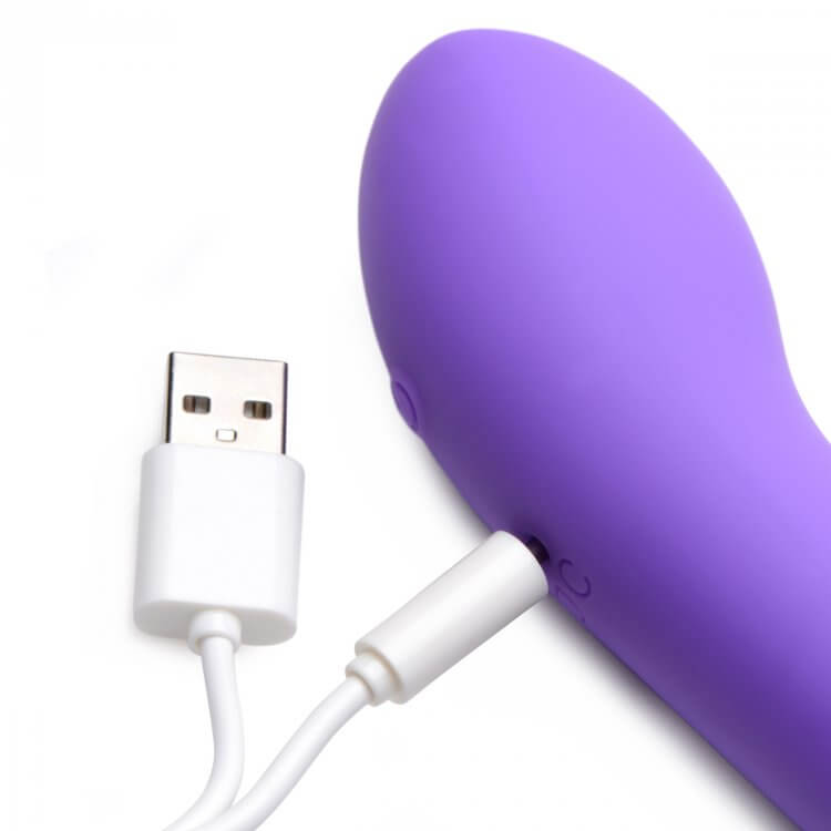 Purple silicone G-Spot vibrator with USB charging cable.