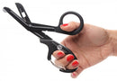 Hand holding Master Series Snip Heavy Duty Bondage Scissors by XR Brands for BDSM safety and preparedness.