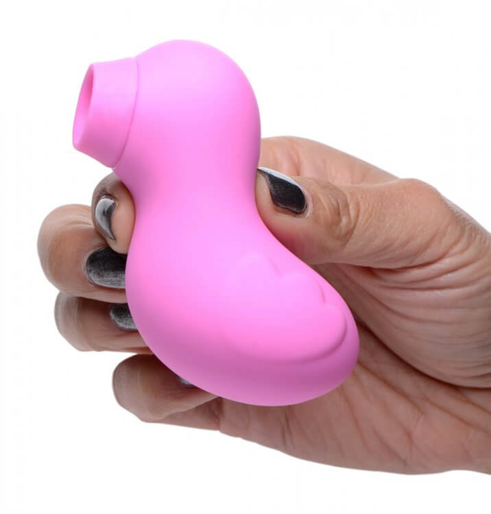 Hand holding Shegasm Sucky Duck Clitoral Stimulator, a pink duck-shaped waterproof suction device.