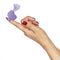 Woman holding Inmi Shegasm Mini 12X Clit Stimulator in purple, demonstrating its compact and ergonomic design