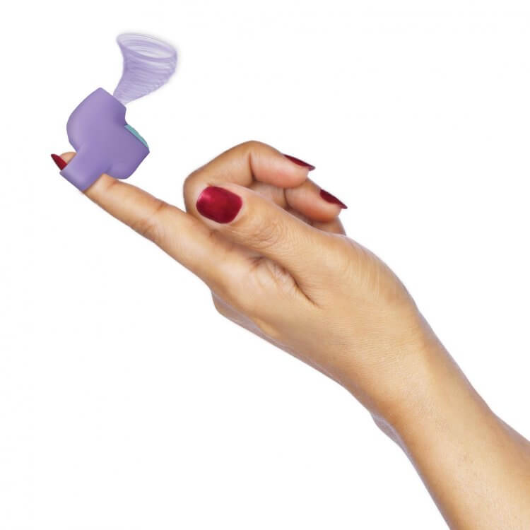 Woman holding Inmi Shegasm Mini 12X Clit Stimulator in purple, demonstrating its compact and ergonomic design