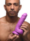 Man holding Pop Peckers 8.25-Inch Purple Dildo with Suction Cup by XR Brands.