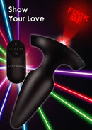 Booty Sparks anal plug with remote control and laser light projecting "Fuck Me" against colorful background.