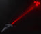 "Booty Sparks anal plug projecting red laser light 'Fuck Me' in dark background"