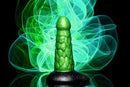 Radioactive Reptile Thick Scaly Dildo in metallic green with black base on glowing green background
