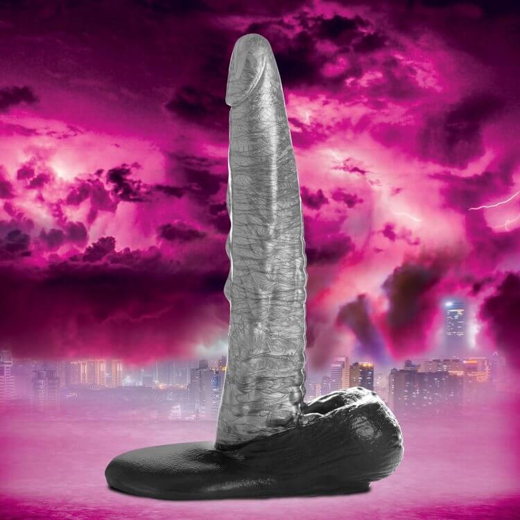 Creature Cocks The Gargoyle Rock Hard Dildo with ridged shaft and suction cup base against a dramatic pink and purple sky background