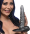 Woman holding the Creature Cocks The Gargoyle Rock Hard Dildo with ridged shaft and suction cup base.
