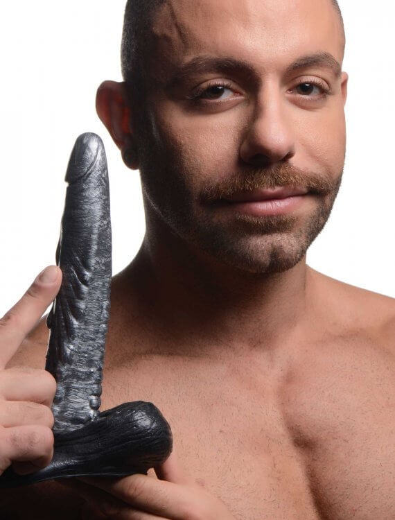 Man holding Creature Cocks The Gargoyle Rock Hard Dildo with ridged shaft and black balls.
