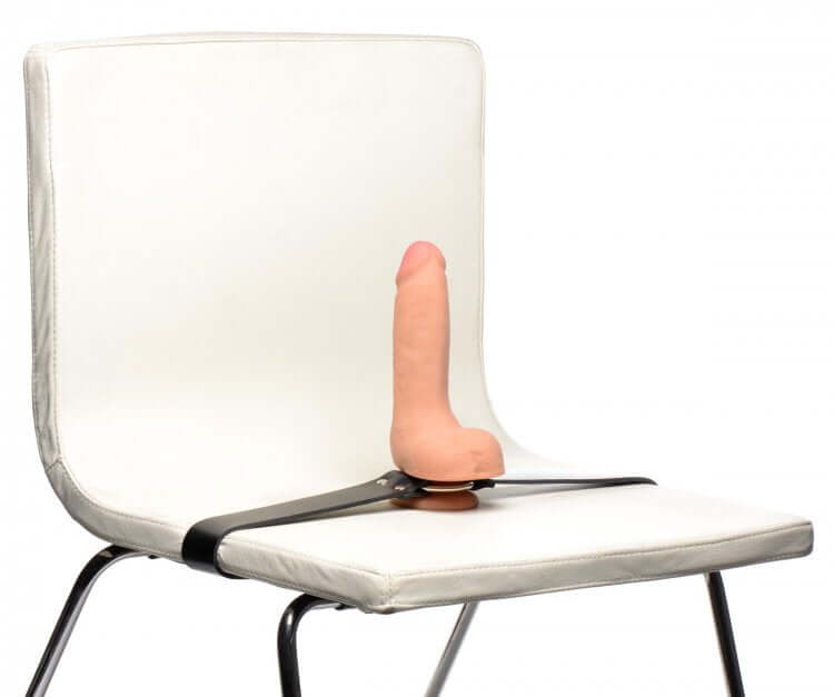 Master Series Strap and Ride Dildo Strap Harness attached to a chair, showcasing versatile positioning options.