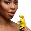 Beautiful woman holding the Shegasm Sucky Bee Clit Stimulator Finger Vibe in vibrant yellow, showcasing its playful design.
