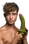 Man holding the green Swamp Monster Silicone Dildo with scaly ridges and realistic texture.