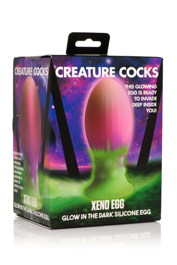 Creature Cocks Xeno Egg Glow-In-The-Dark Silicone Egg in packaging with vibrant cosmic design.