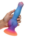 Hand holding Creative Cocks Space Cock Glow-In-The-Dark Silicone Dildo with colorful design