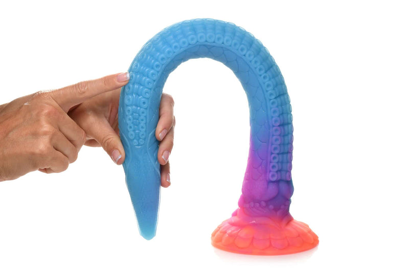 Hand holding Makara glow in the dark silicone snake dildo in blue and pink by Creature Cocks