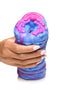 Close-up of a hand holding the vibrant, extraterrestrial-designed Creature Cocks Cyclone Squishy Alien Vagina Stroker by XR Brands.