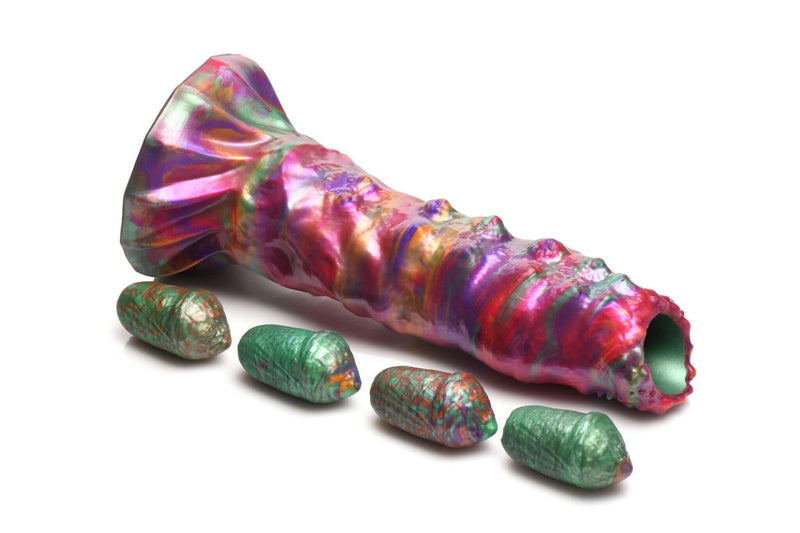 Vibrant Creature Cocks Larva Silicone Ovipositor Dildo with Eggs featuring iridescent colors of pink, green, orange, and purple.