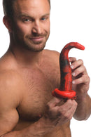 Shirtless man holding the Creature Cocks King Cobra Silicone Dildo with a tapered head and scaly texture.