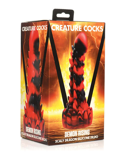 Creature Cocks Demon Rising Scaly Dragon Silicone Dildo in packaging against a fiery backdrop
