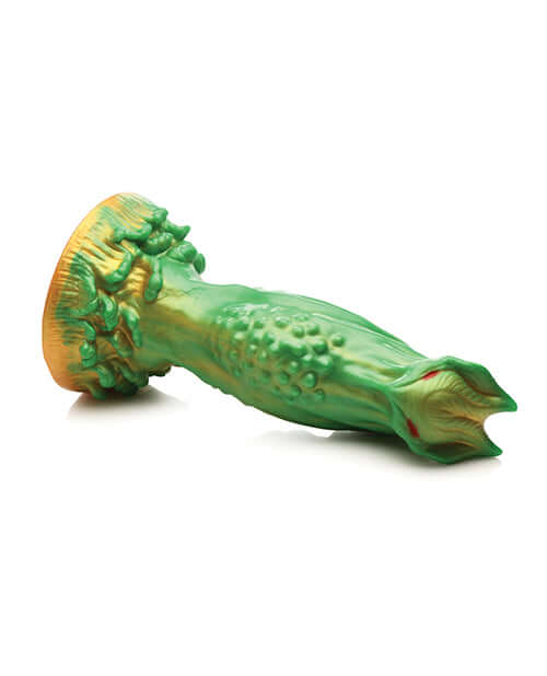 Creature Cocks Nebula Alien silicone dildo by XR Brands in green and gold with narrow red eyes for a galactic intimate adventure.