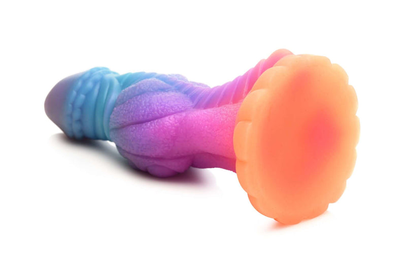 Glow-in-the-dark alien dildo Galactic Cock by XR Brands in pink, orange, blue, and purple with sparkling glitter - side view.