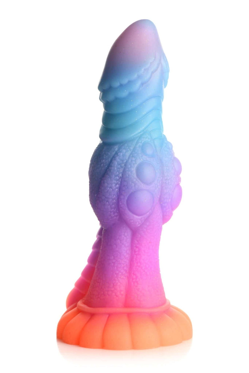 Glow-in-the-dark alien dildo in colorful hues of pink, orange, blue, and purple with glitter accents by XR Brands.