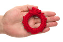 Hand holding red dragon-themed silicone cock ring from XR Brands' Creature Cocks Rise of the Dragon collection