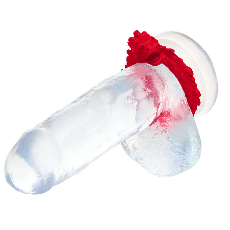 Red dragon-themed silicone cock ring by XR Brands on transparent dildo