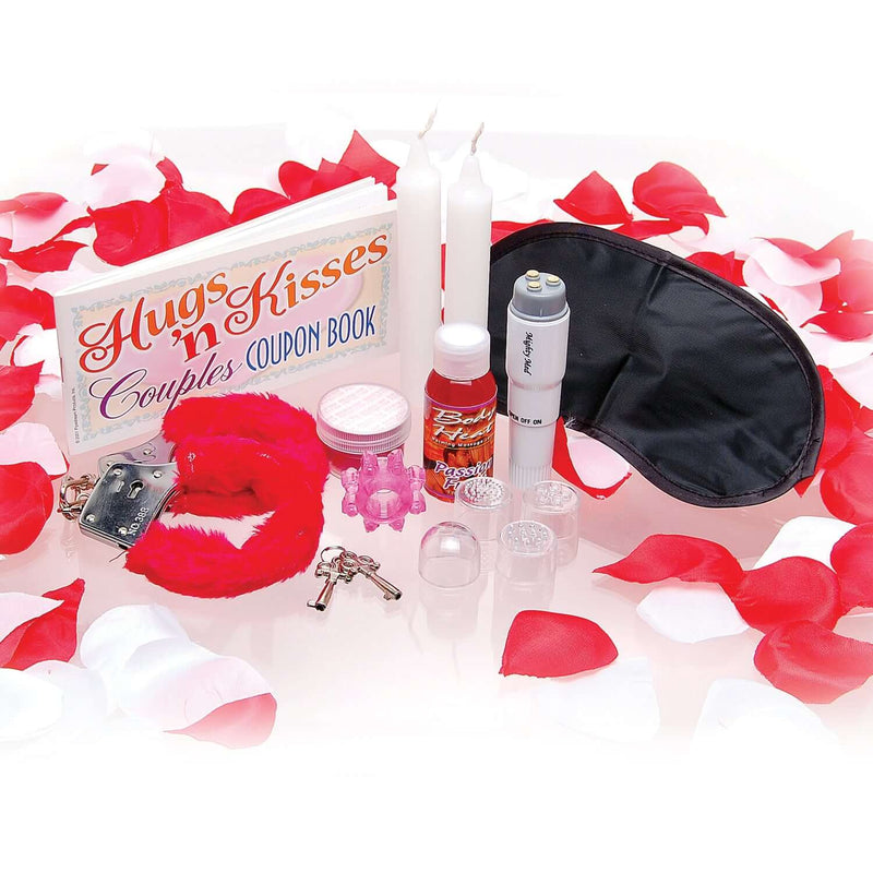 Sex Therapy Kit for Lovers with furry cuffs, blindfold, candles, couples coupon book, and sensual massage items surrounded by rose petals.